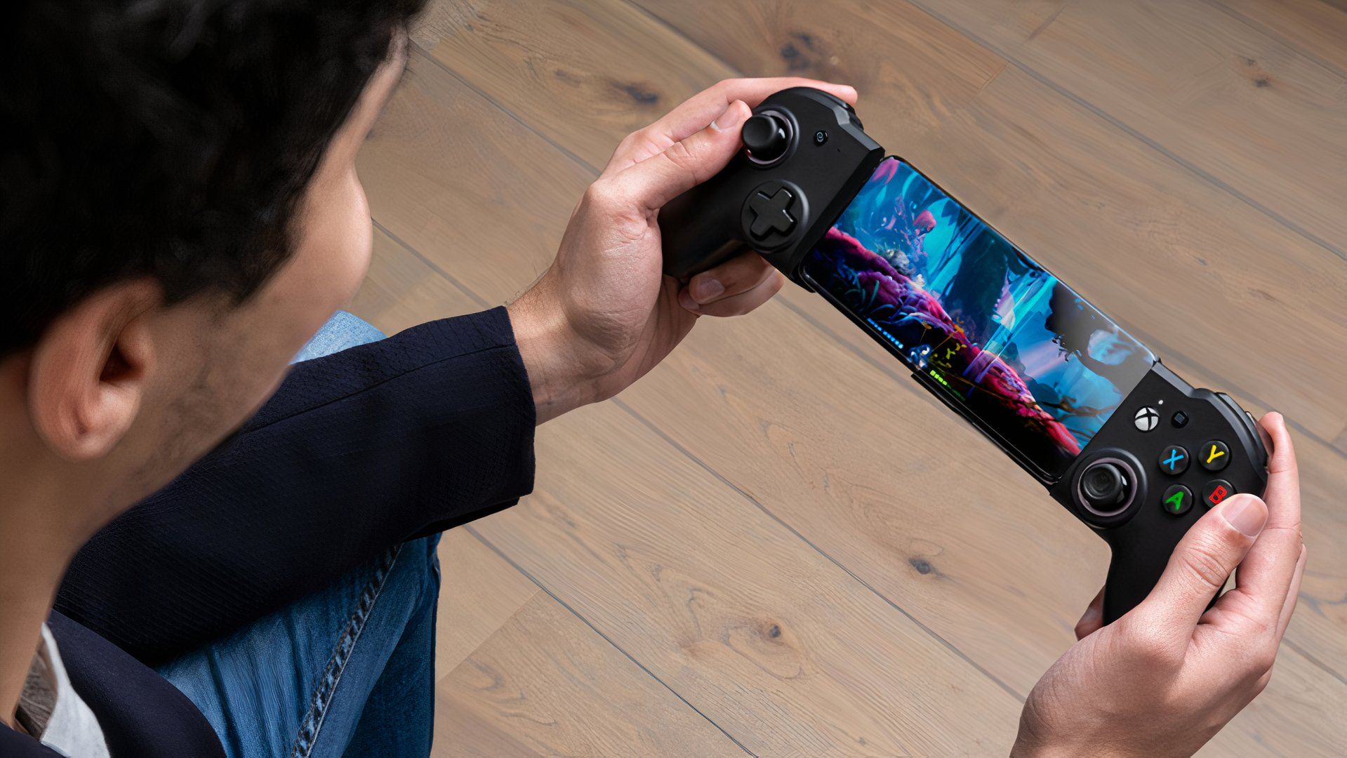 Someone playing a game on a phone in the RIG Nacon MG-X Pro
