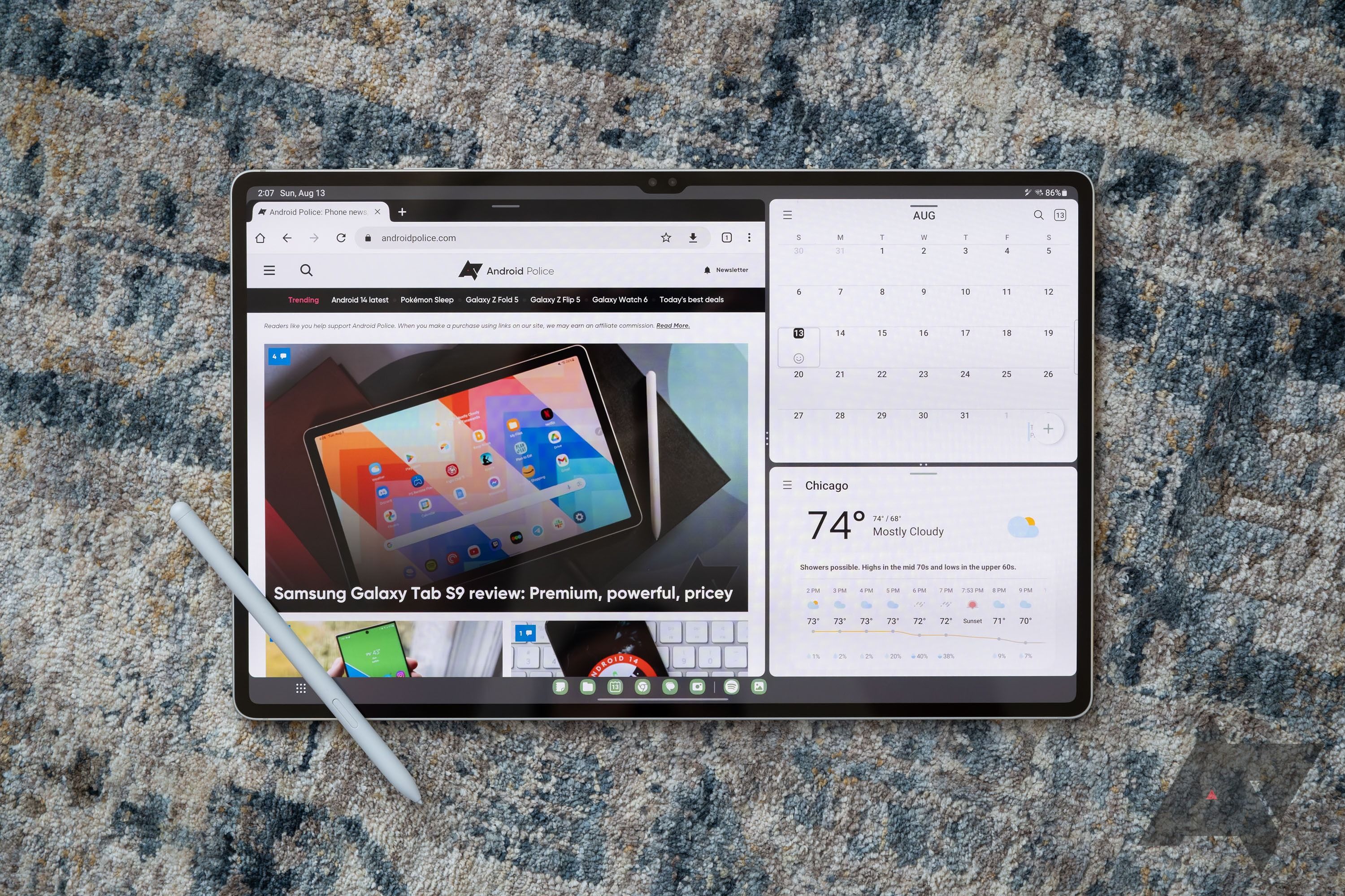 A large tablet with a stylus, displaying three apps in a multitasking interface. 