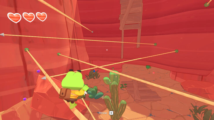 Big Hops - A frog walks on a tightrope through a red desert area.