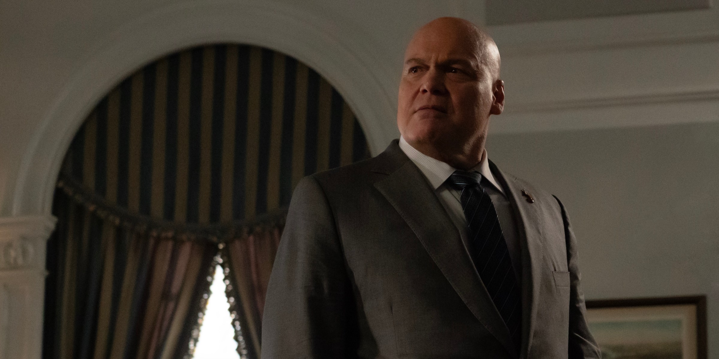 Vincent D’Onofrio as Kingpin/Wilson Fisk standing in his mayoral office in a gray suit in Daredevil: Born Again