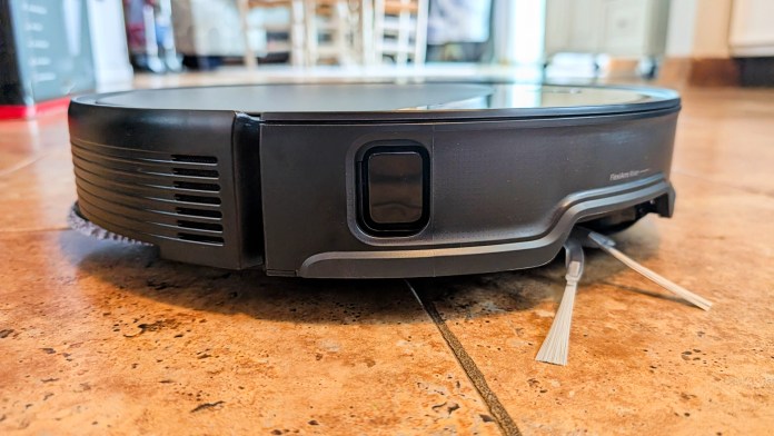 Close-up view of the Roborock Saros 10R robot vacuum, showcasing its sleek design and low profile against a tiled floor.