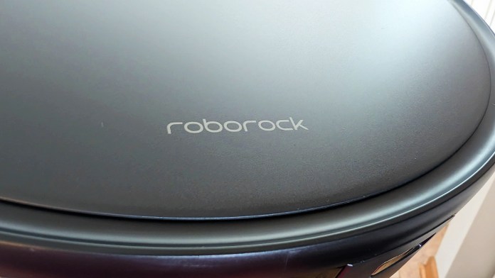 Close-up view of the Roborock Saros 10R robot vacuum with the brand name 'roborock' displayed on its surface.