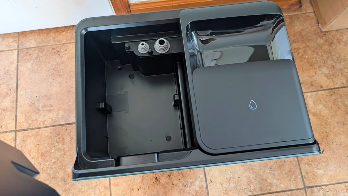 Close-up view of the Roborock Saros 10R multifunctional dock, showing its water and waste compartments.
