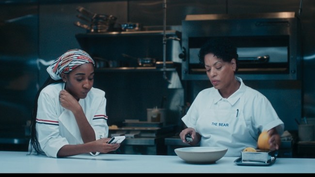'The Bear' Season 4 stars (l-r) Ayo Edebiri as Sydney Adamu, Liza Colon-Zayas as Tina, shown here working in the kitchen
