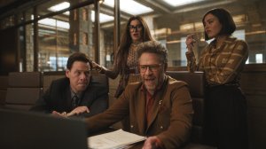'The Studio' stars Seth Rogen, Ike Barinholtz, Chase Sui Wonders, and Kathryn Hahn, shown here in a conference room looking over Rogen's shoulder at a computer