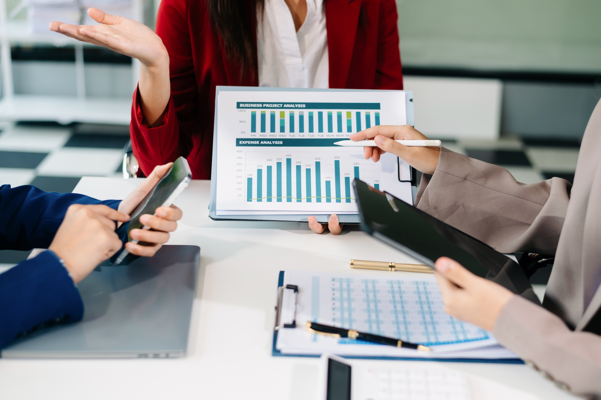 Businessman and team analyzing financial statement Finance task. with smart phone and