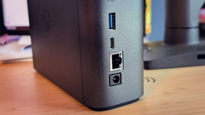 Close-up view of the Synology BeeStation Plus, showing its black casing and various ports including USB and Ethernet on the back.