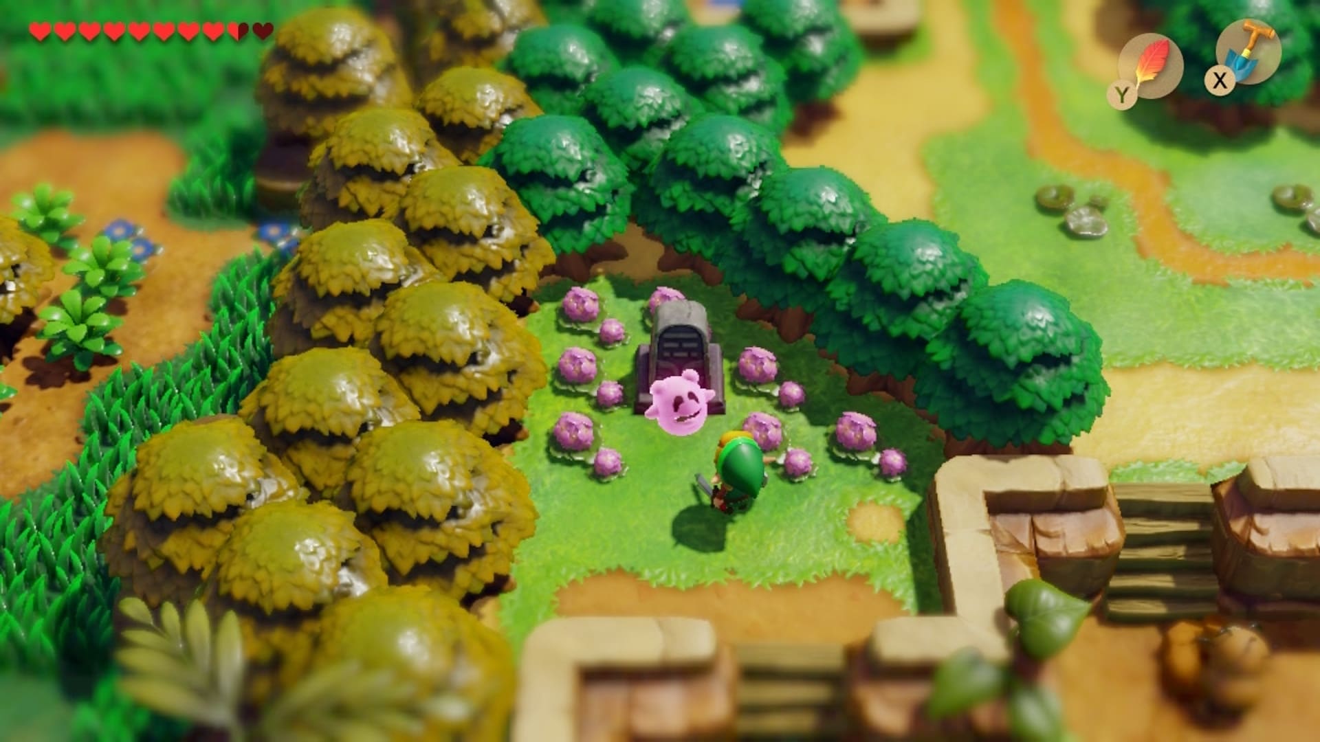 A vibrant, animated scene from a video game shows a character in green standing near a gravestone surrounded by pink ghost-like figures among lush trees