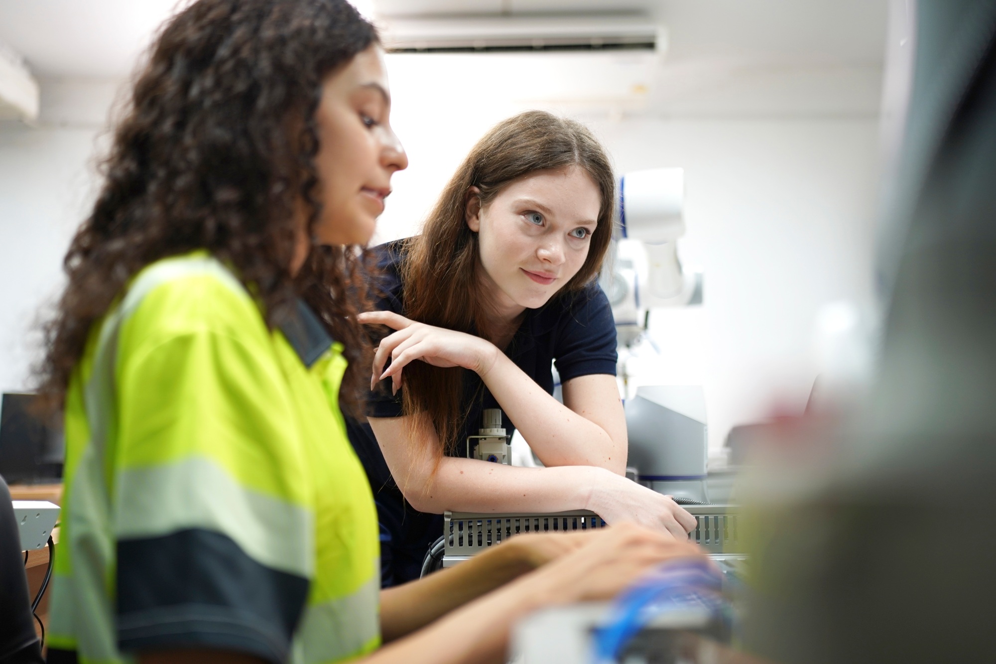 Colleagues collaborate on a technical project in a modern workspace during the day