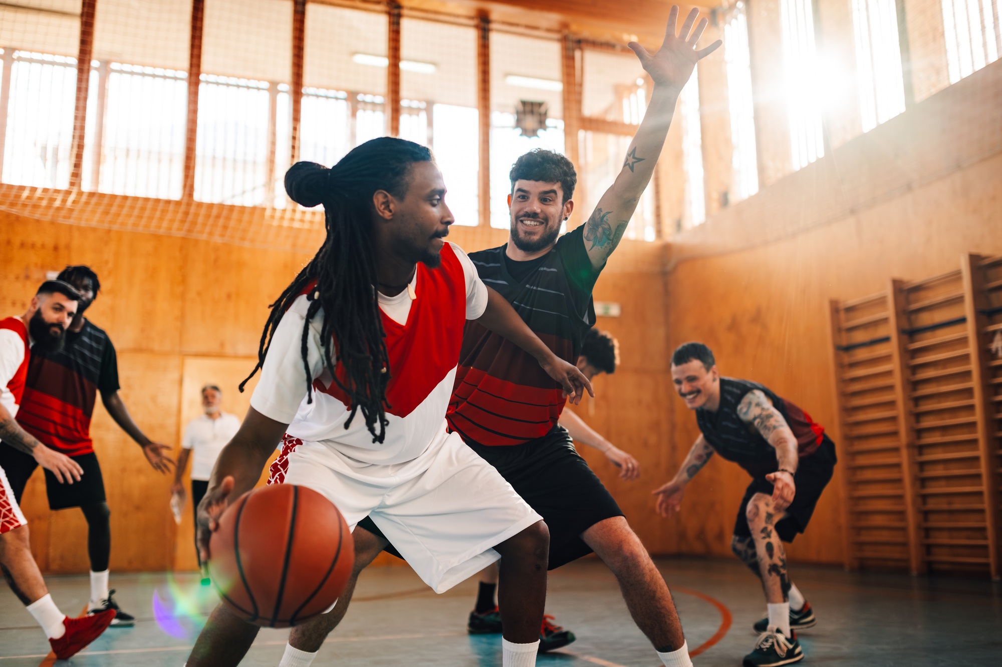 Multicultural basketball players playing basketball on training.