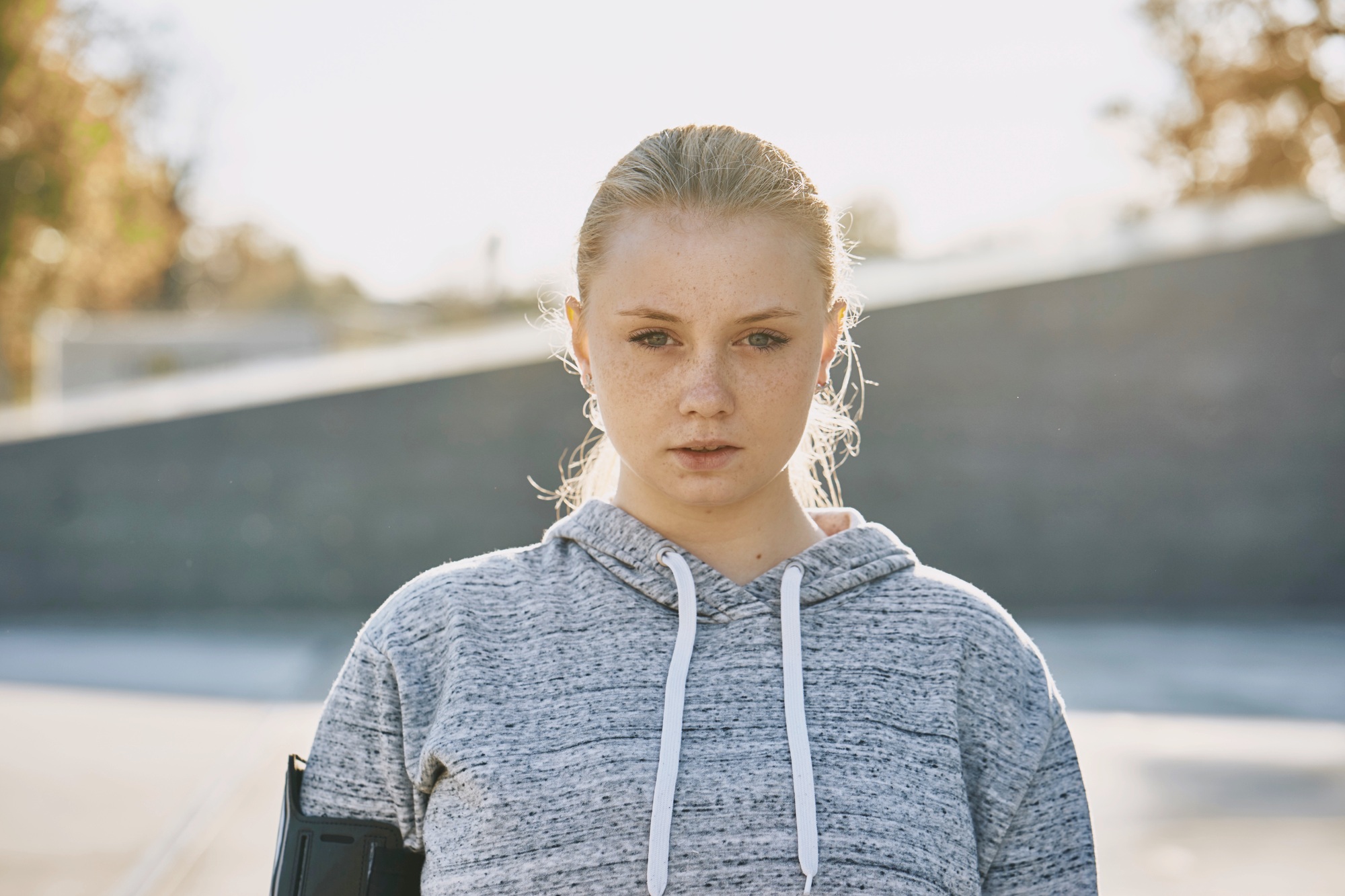 Young woman training, backlit portrait