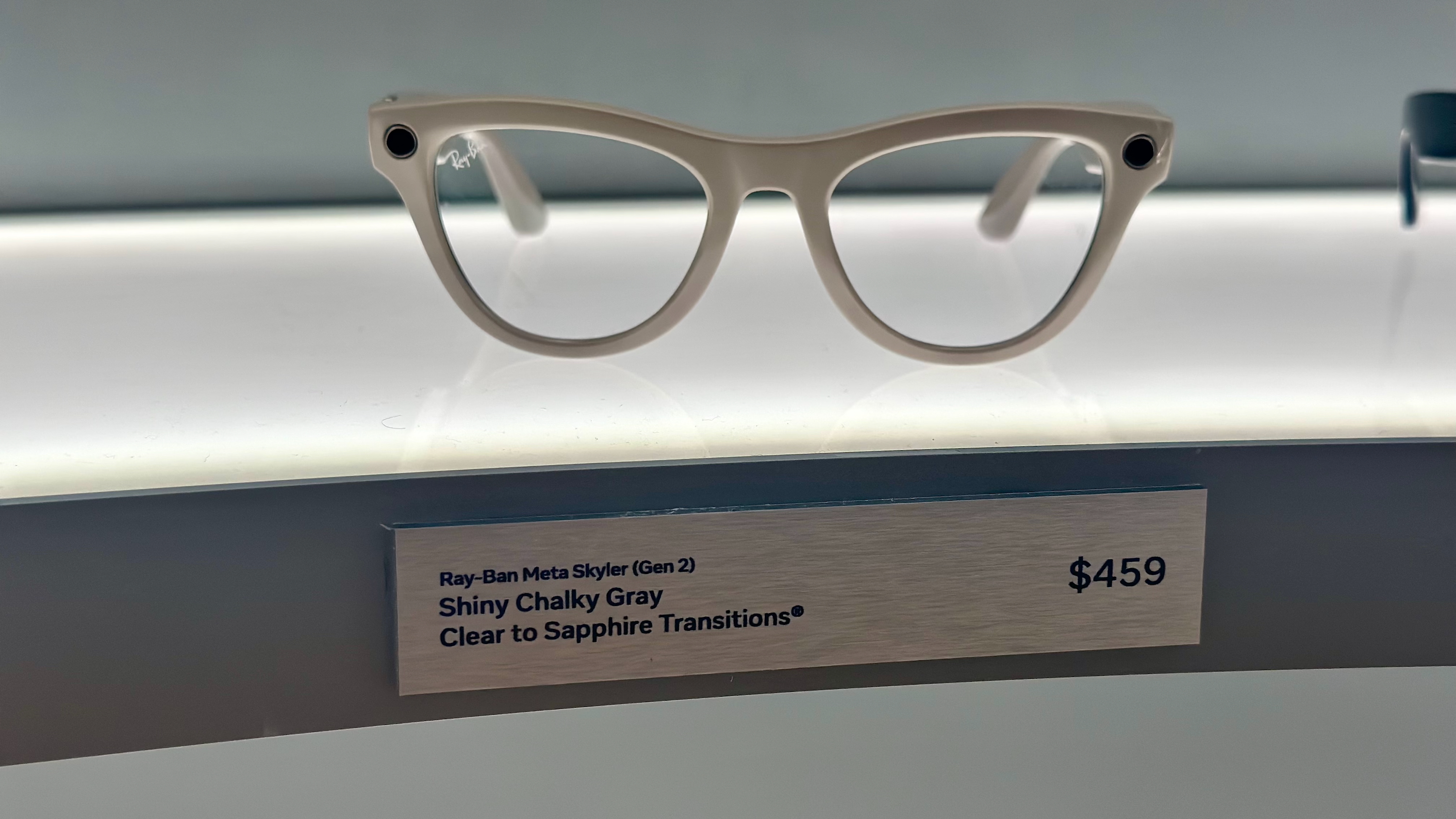 Skyler Ray-Ban Meta (Gen 2) glasses on display in Shiny Chalky Gray with Clear to Sapphire Transitions lenses.