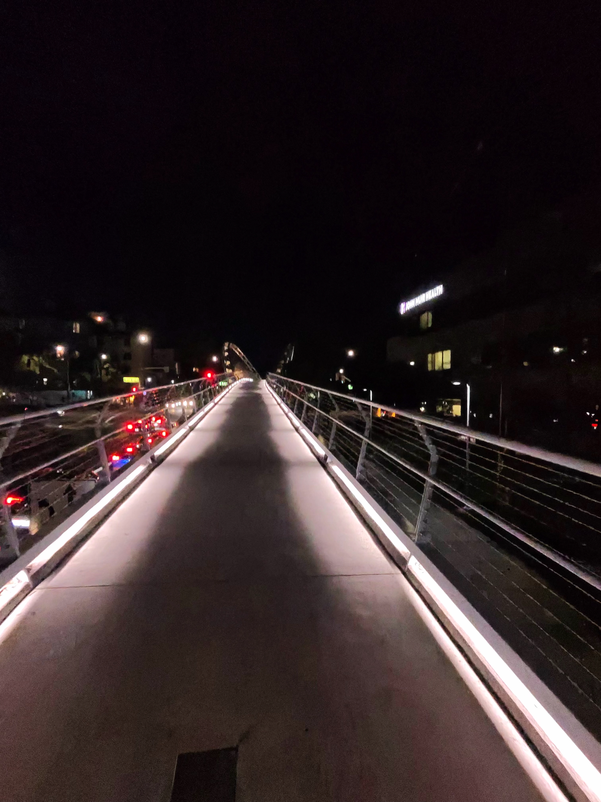 A photo taken with the Ray-Ban Meta (Gen 2) smart glasses showing a lit-up bridge at night.