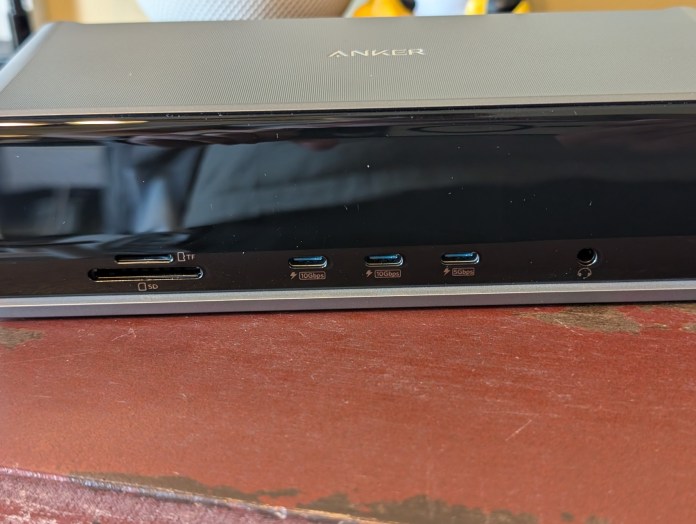 Close-up view of the front panel of the Anker Prime Docking Station showing the microSD and SD card slots, three USB-C ports, and a headphone/mic combo port.