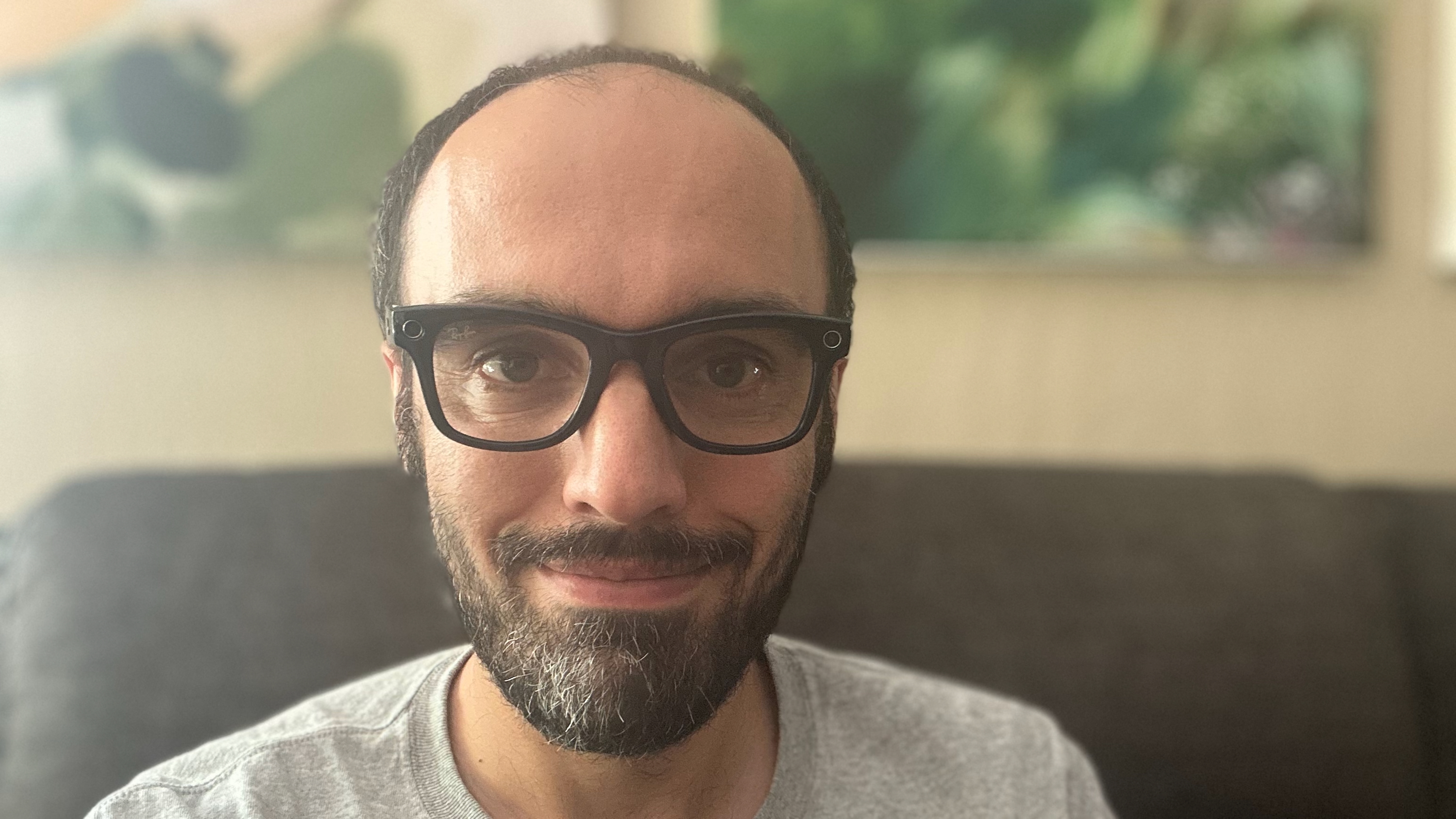 Selfie of the author wearing Ray-Ban Meta (Gen 2) Wayfarer glasses, sitting indoors on a couch.