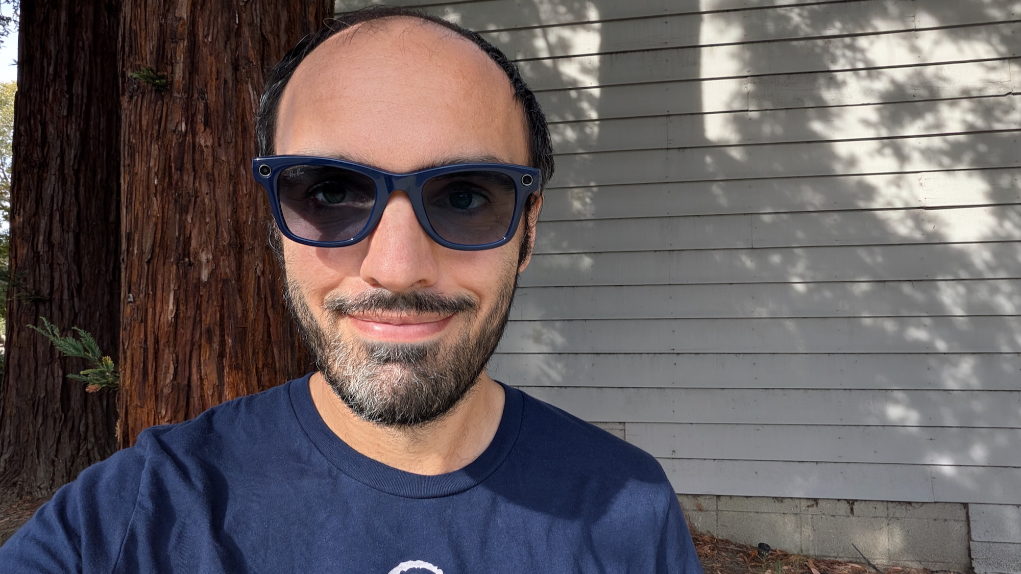 A selfie of the author wearing Ray-Ban Meta (Gen 2) glasses with Shiny Cosmic Blue frames and transitions lenses.
