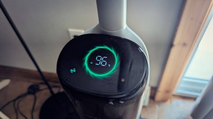 Close-up view of the LED display on a Dreame H15 Pro vacuum, showing battery percentage and status indicators.