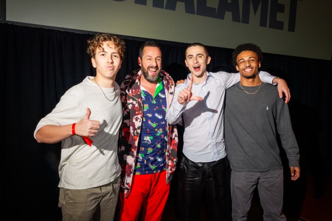Adam Sandler and Timothee Chalamet surrounded by the players who smoked them at the Fairfax High School gym.